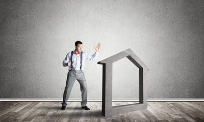 Obraz premium Stone home silhouette in empty room as symbol for real estate insurance