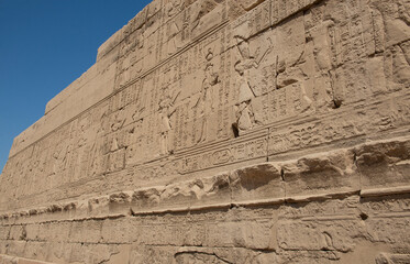 Ancient egyptian temple wall with hieroglyphic carvings
