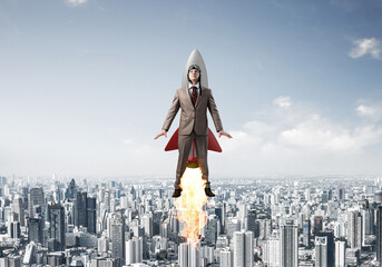 Business person in aviator hat flying on rocket