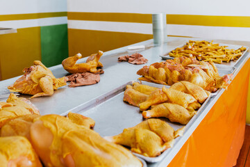Latin Poultry shop or Polleria with raw chicken breast being sliced by the Pollero at Chicken shop in Mexican market in Mexico Latin America