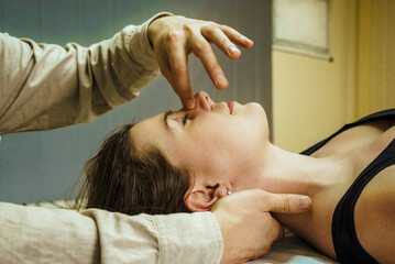 Obraz na płótnie Canvas a woman at a CST treatment session, Osteopathic Manipulation and CranioSacral Therapy 8