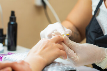 Hands close-up in a beauty salon on a manicure. Background, selective focus