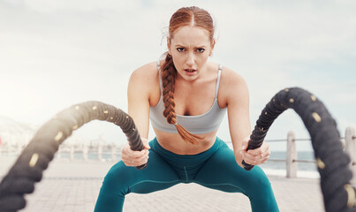 Woman, battle rope exercise and portrait at ocean park for fitness, strong body and wellness at outdoor training. Girl, focus and workout by sea with goal, target or motivation for muscle development
