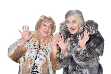 senior women in fur coats isolated on white background