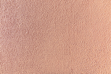 Fototapeta premium Textured pink wall, very rough to the touch.