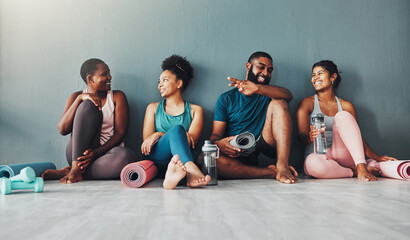 Yoga, fitness group and diversity of pilates class in a gym with a exercise and training break. Talking, wellness people and communication of friends on a floor ready for zen, balance and relax