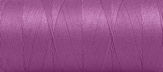 Fotobehang Texture of threads in a spool of purple color on a white background © Minakryn Ruslan 