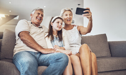 Selfie, love or happy grandparents with girl in living room bonding as a family in Australia taking pictures. Smile, senior or elderly man relaxing with old woman or child at home together on holiday
