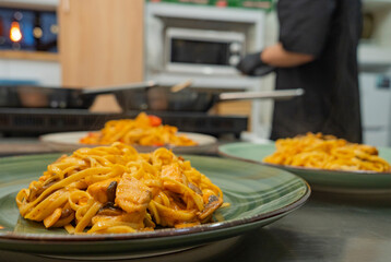 Asian noodles on a plate in the restaurant kitchen before being served to the customer