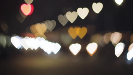 heart love shape background bokeh blurred,many objects, colored red yellow orange blue, glow moving, car lights on the road blur, at night. concept background heart love.
