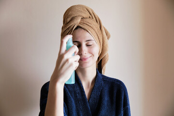 young woman at home takes care of her problem skin with acne