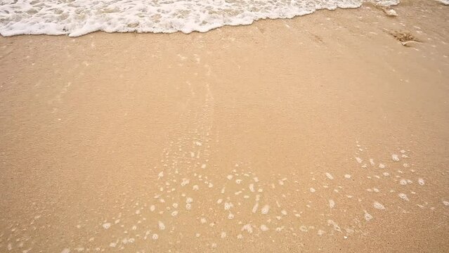 Close up top angle of small wave, Soft wave on sand beach for opening video, text space. white sand beach