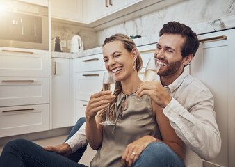 Laughing, love and couple with champagne in the kitchen for celebration, anniversary and valentines day. Comic, relax and funny man and woman drinking alcohol on the floor with happy conversation