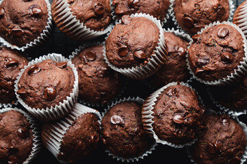 Overhead close up of many chocolate chip zucchini muffins.