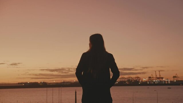 girl standing on hill as the sun La Parouse Sydney Australia