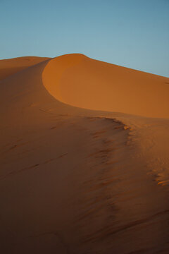Abstract photograph of sand dunes shot at sunset in Merzouga, Morocco