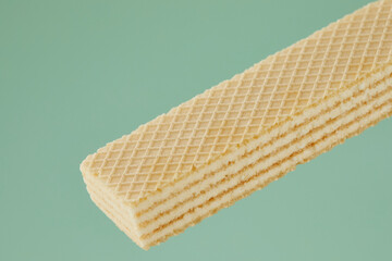 wafer cookies with white filling on a green background. close-up of a confectionery product. High quality 4k footage