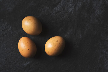Eggs on black background on rustic black background