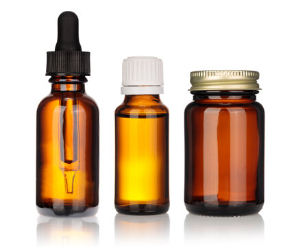 Various Brown Dropper Bottles Of Glass Pipette For Medicine Pills In Row, Are Arranged In Set And Displayed On White Background.