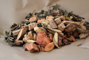 Traditional Chinese medicine herb ingredient on brown paper background. Plant herbal as alternative heal hemorrhoids disease. Maintain body spirit health and balance energy