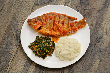 Tilapia stew, ugali(white maize flour mash) and Sukuma Wiki(kale stew), Kenyan food