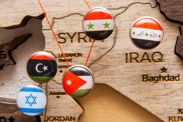 Syria, Iraq, Israel, Libanon, Iran flags on the push pins and red thread on the wooden map, close...