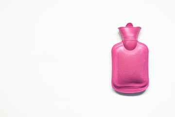 Pink hot water bottle on a white background