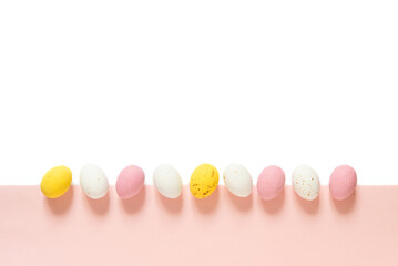 candy Easter eggs on a light white pink background. Happy easter flat lay. copy space