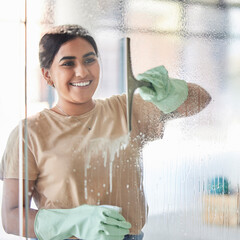 Happy, smile and girl cleaning window with spray bottle and soap or detergent, housekeeper in home...