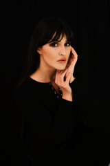 Close up woman portrait on black background