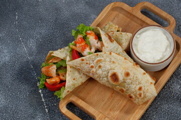 Shawarma chicken roll in a pita with fresh vegetables
