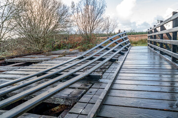 Fototapeta premium An old, rotten wooden bridge over the Owenea river by Ardara in County Donegal - Ireland