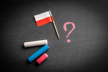 Polish flag and question mark on a chalk board. p Politics and economics concept
