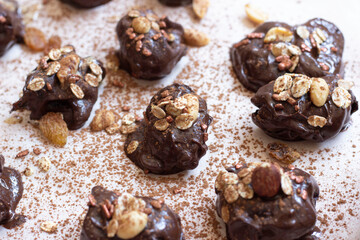 Sweet chocolate vegan dessert of dates and almonds in the kitchen on the table