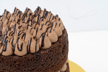 Wonderful Chocolate Naked cake with a cream topping and chocolate syrup made with love.