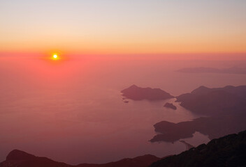 Summer scenery of Blue Lagoon with white sand located in city Oludeniz. Beautiful view on summer sea and town from top moutain. Sunset time