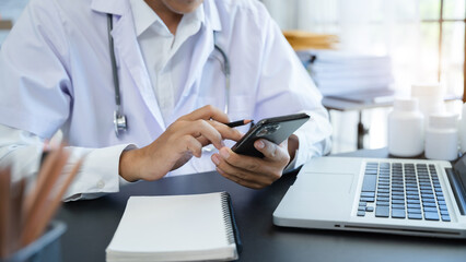 Doctor texting and sms with smartphone texting patient.