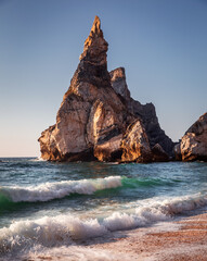 Naklejka premium Praia da Ursa in summer with waves and rocks