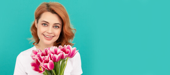 happy woman with tulip flower bouquet on blue background. mothers day. Woman isolated face portrait, banner with mock up copyspace.