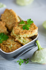 vegetable fried squash and zucchini cutlets in a ceramic form