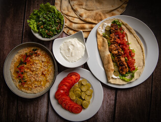 Lebanese recipe of chich taouk, garlic cream, toum, in a Lebanese bread, tabbouleh and chickpea...