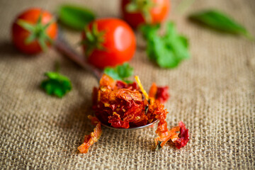 small pieces of dried tomatoes next to fresh tomatoes