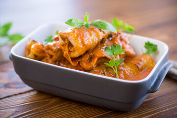 Traditional stuffed cabbage with minced meat and rice, served in a tomato sauce.