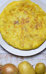 Zenith view, homemade potato and onion omelet, typical of Spain.
Vertical shot.
