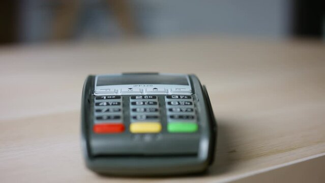 Hand using nfc technology on cellphone for purchase closeup. Terminal payment 