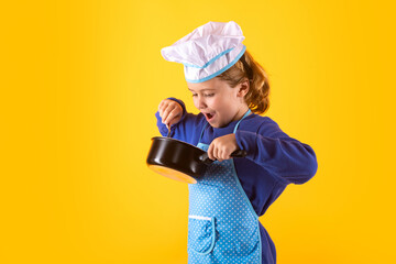 Kid chef cook with cooking pot stockpot. Cooking children. Chef kid boy in form of cook. Child boy...