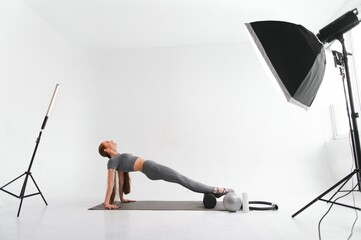 Blog about sports , fitness video tutorial. A slender girl in a sports outfit records training videos on camera. Online Learning Concept