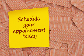 Schedule your appointment today on sticky note with lots of fabric adhesive band aids
