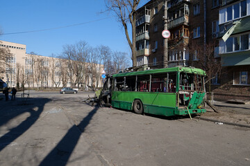 Fototapeta premium Russian missile destroyed green trolleybus and houses in Kyiv, Ukraine