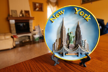 New York souvenir plate on a stand at home.